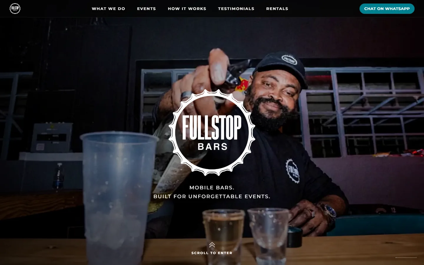 The Fullstop Bars homepage: the circular Fullstop Bars mark over photography of a bartender pouring at an event, with a Chat on WhatsApp action